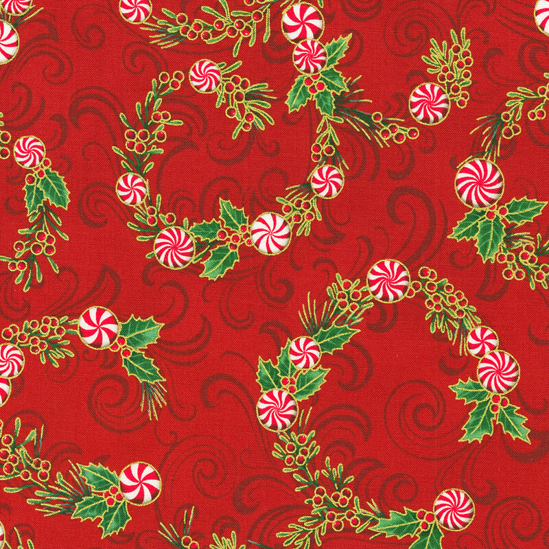 Red fabric featuring swirling patterns of green holly leaves and red-and-white peppermint candies.