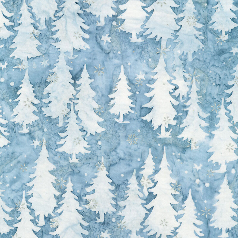 Fabric featuring a light blue background with white tree silhouettes and scattered metallic snowflakes.