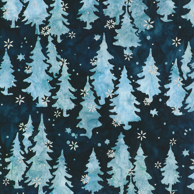 Batik fabric pattern with light blue trees and metallic stars on a dark background. Winter-themed design.