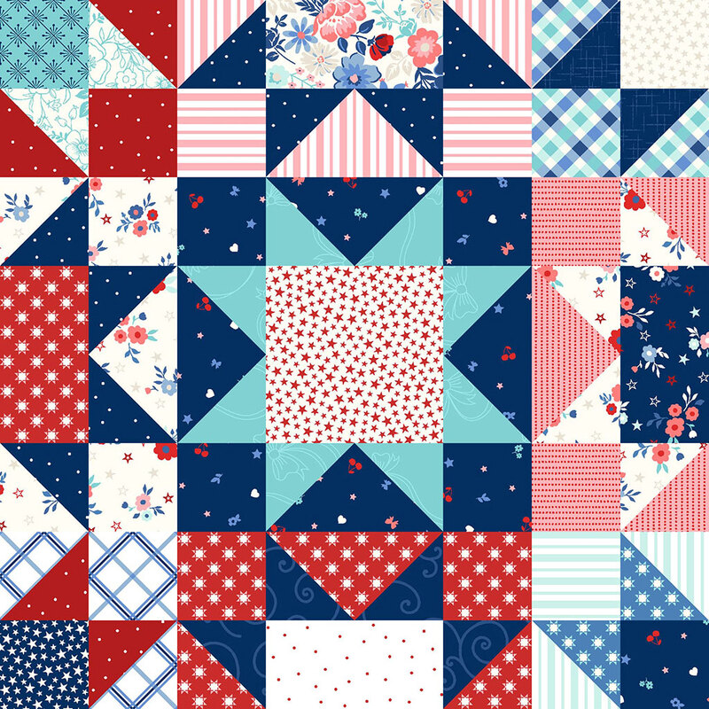 Colorful patchwork quilt featuring various red, blue, and white geometric patterns and floral designs.