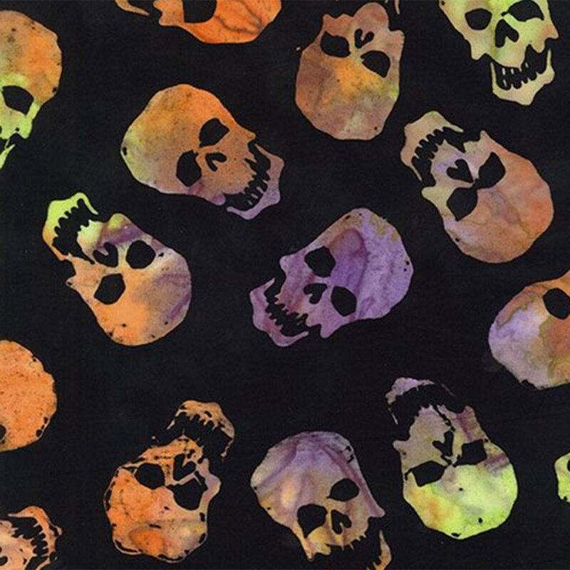 Black batik fabric with multi-colored orange, purple, and green skulls throughout