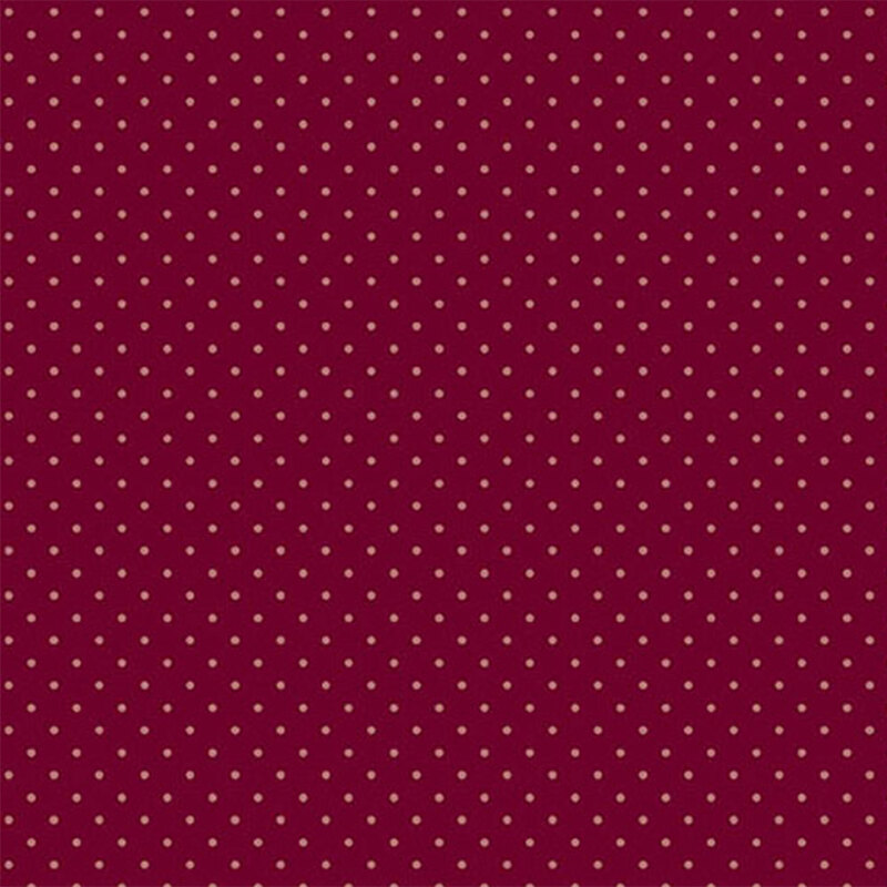 Burgundy fabric with a repeating pattern of small gold dots throughout.