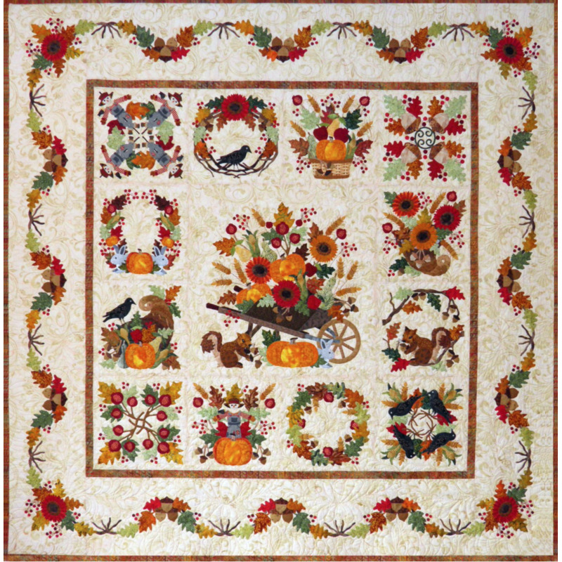 Colorful quilt featuring autumn themes: pumpkins, flowers, squirrels, and birds in a patchwork design. Baltimore Autumn Quilt