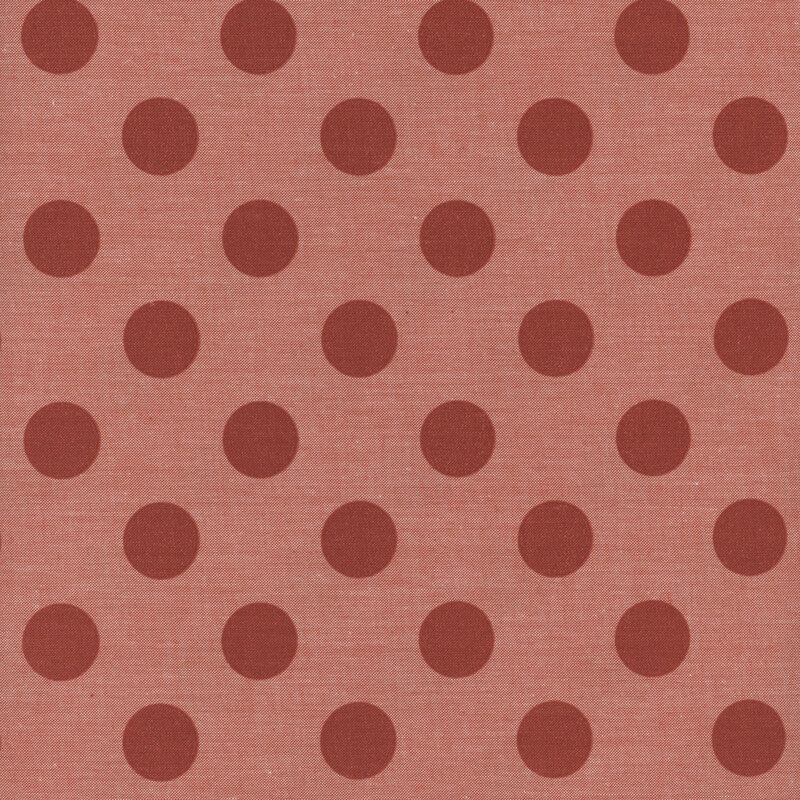 Carrot orange fabric with dark tuscan red polka dots.