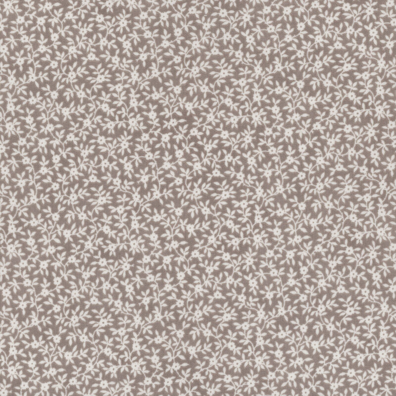 Pattern of small white floral designs on a gray background.