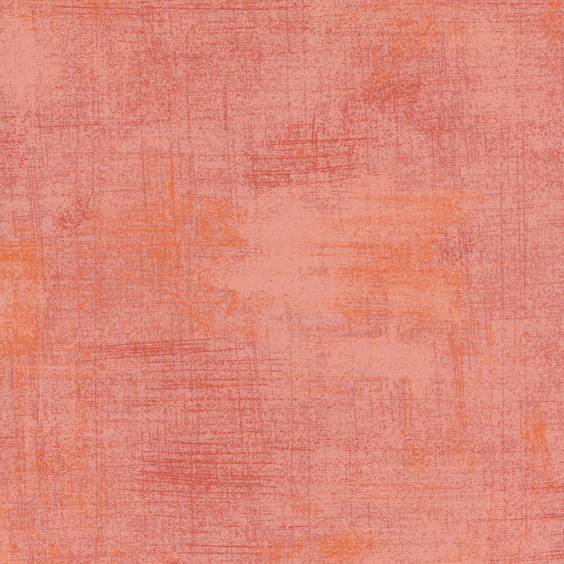 Pink and peach mottled and grungy-textured fabric.