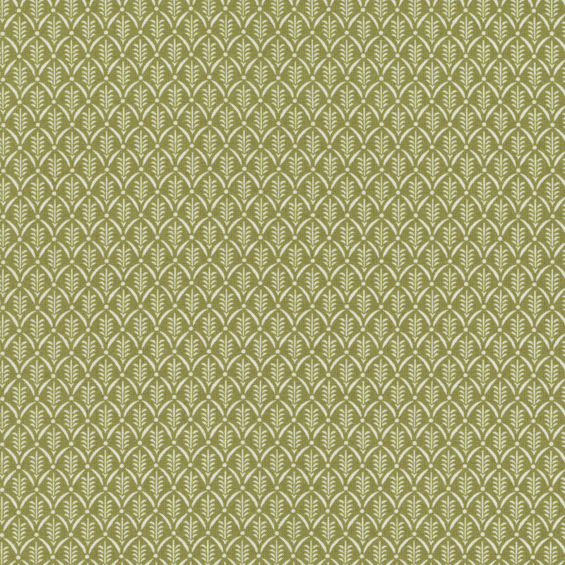 Green fabric with a white pattern of scallops framing little sprigs.