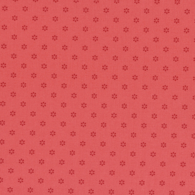 Tonal red fabric with a repeating pattern of small, subtle flower shapes.