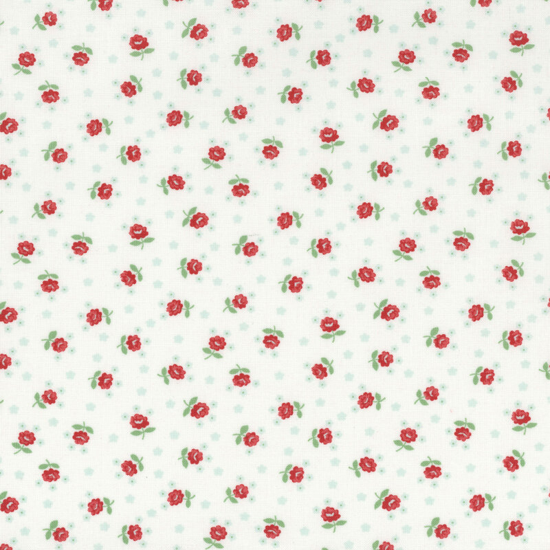 White fabric scattered with small red roses and tiny light aqua floral motifs