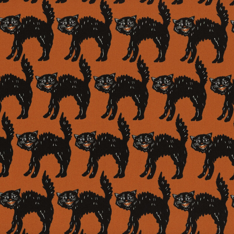 Orange fabric with symmetrical rows of hissing black cats.