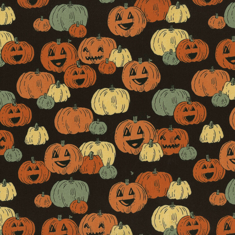 Black fabric featuring clusters of colorful pumpkins with cut-out smiling faces.