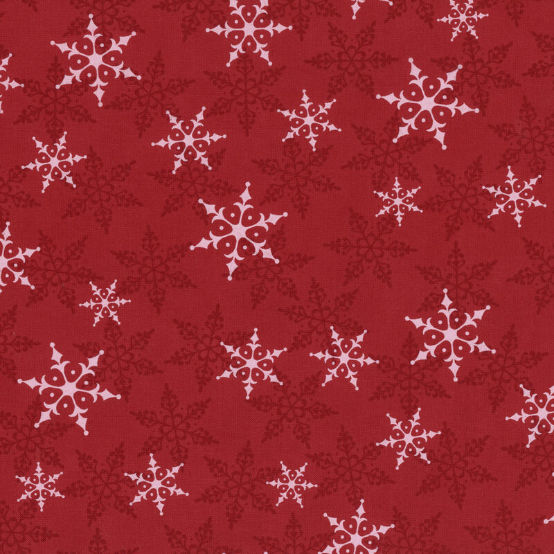 Red fabric with white and tonal snowflakes tossed across the design.