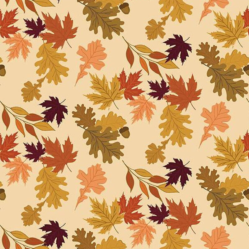 Fabric with various autumn leaves in warm colors on a beige background.