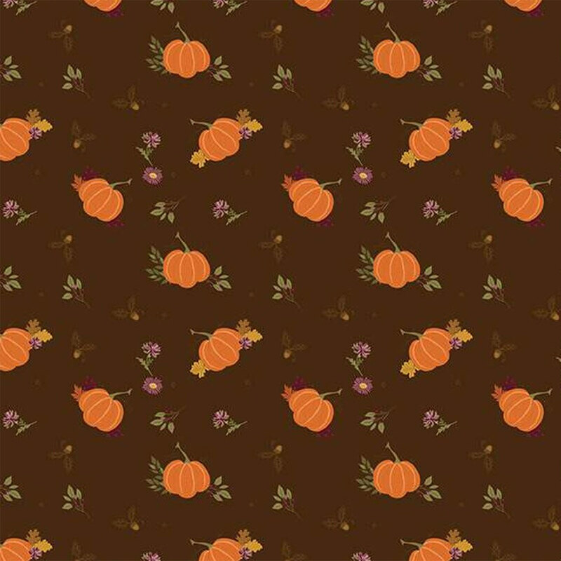 Fabric featuring orange pumpkins and small flowers on a dark brown background.