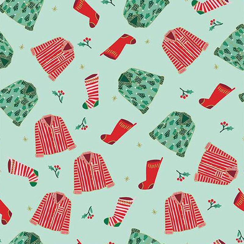 Mint fabric featuring tossed Christmas pajamas, stockings, and holly sprigs