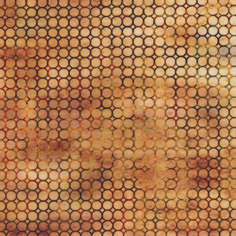 Fabric pattern of circles in warm tones of orange and brown on a textured background.