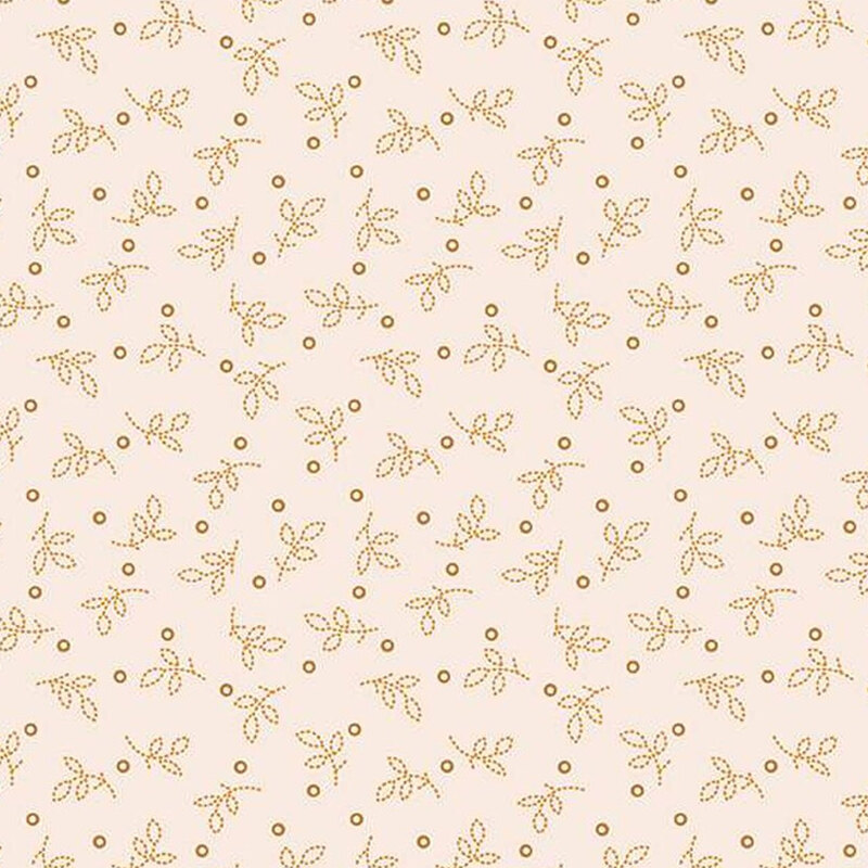 Fabric with small golden leaves and circles on a light beige background.