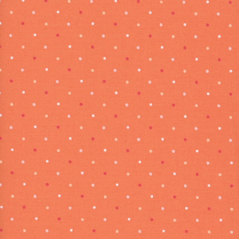 Coral orange fabric with multicolor polka dots.