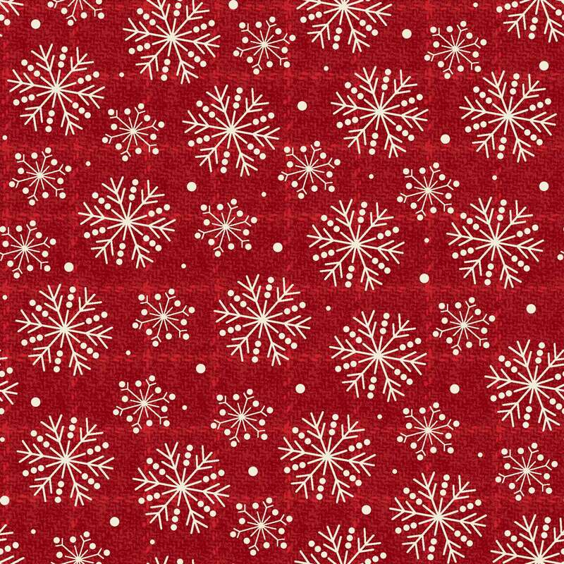 Red fabric featuring a repeated pattern of white snowflakes and small dots.