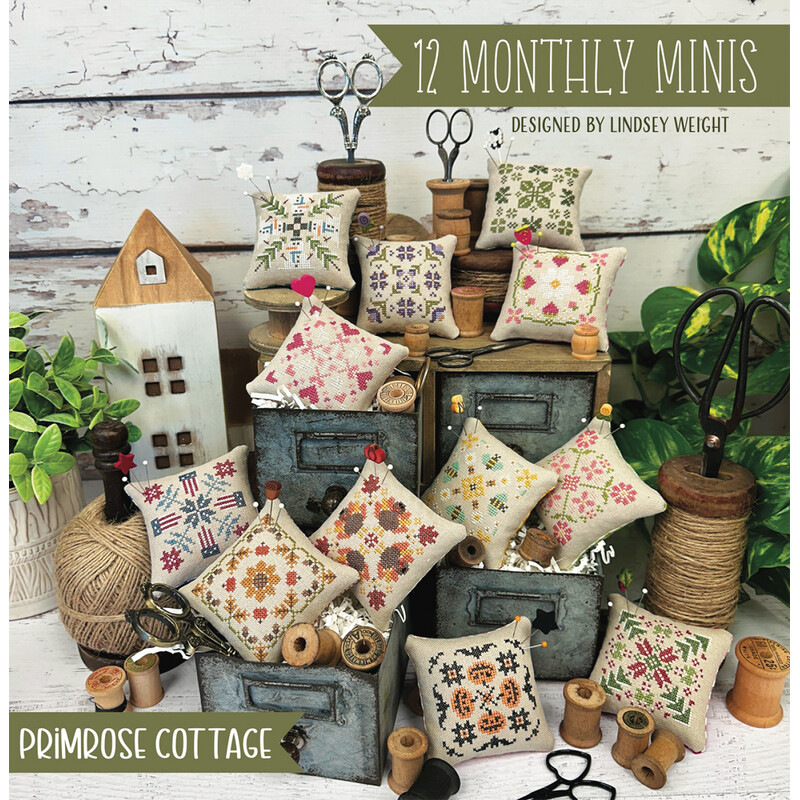 Front cover of the pattern showing all the completed monthly minis artfully staged with rustic decor.