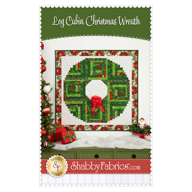 Front cover of the Log Cabin Christmas Wreath pattern, showing the completed projects staged above a green armoire decorated with glittering cotton snow, presents, and a Christmas tree.