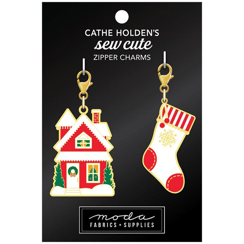 Two colorful zipper charms: a festive house and a Christmas stocking, on a black background.