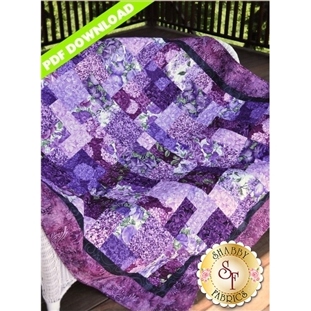 Simple pieced rectangles quilt featuring purple floral fabric collection.