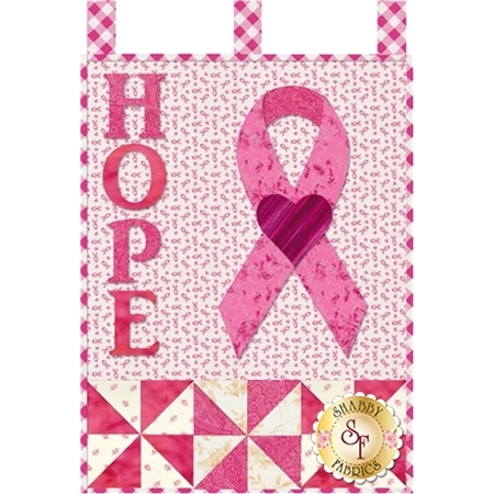 Pink applique letters reading HOPE beside a pink awareness ribbon for breast cancer.