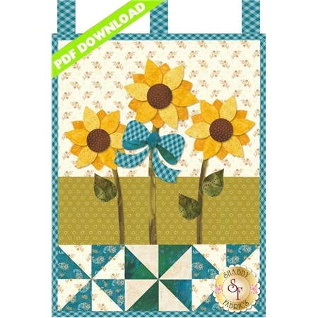 Three yellow sunflowers with a large teal ribbon and teal pinwheels.