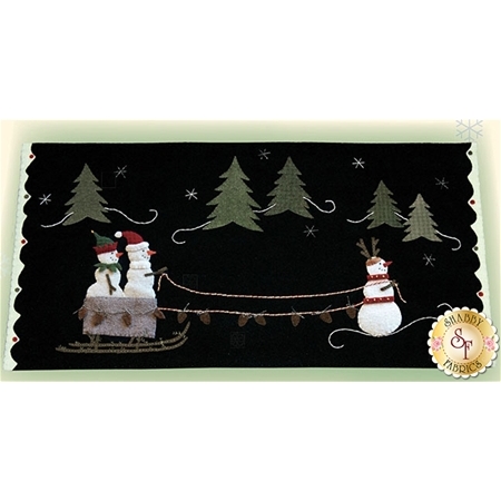 The finished Frosty the Red Nosed Snowman table topper showing two snowmen in a led with a third snowman dressed as a reindeer pulling the sled.