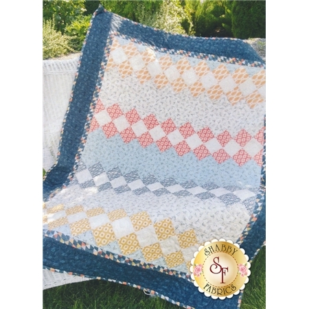 Blue, yellow, and pink patchwork squares with a dark blue border.