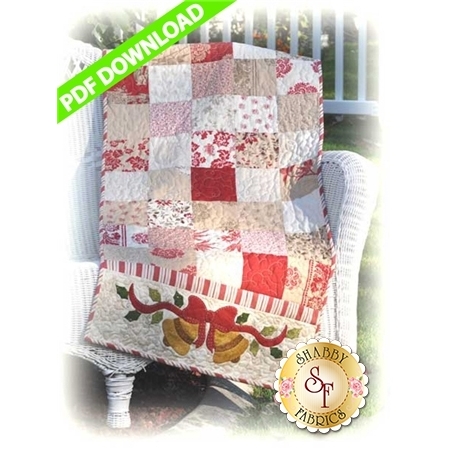 Table runner with red, pink, and white square patchwork with a pair of appliqued Christmas bells.