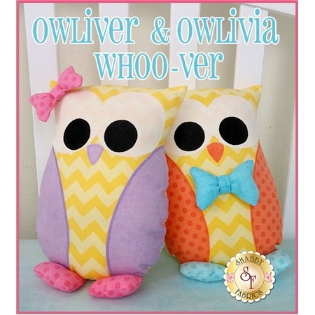A pair of owl pillows in yellow chevron fabric with appliqued eyes and wings.