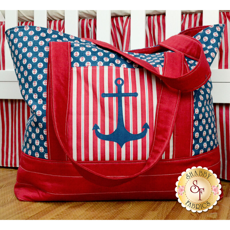 Red and blue nautical themed diaper bag with navy blue center anchor applique.