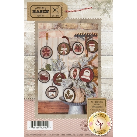 10 Holiday Penny Ornaments Pattern front cover showing all 10 finished ornaments including a poinsettia, a candy cane, a gift, Santa, Santa's boot, a snowy tree, a snowman, a christmas bell, an ornament with a star, and holly leaves with berries.