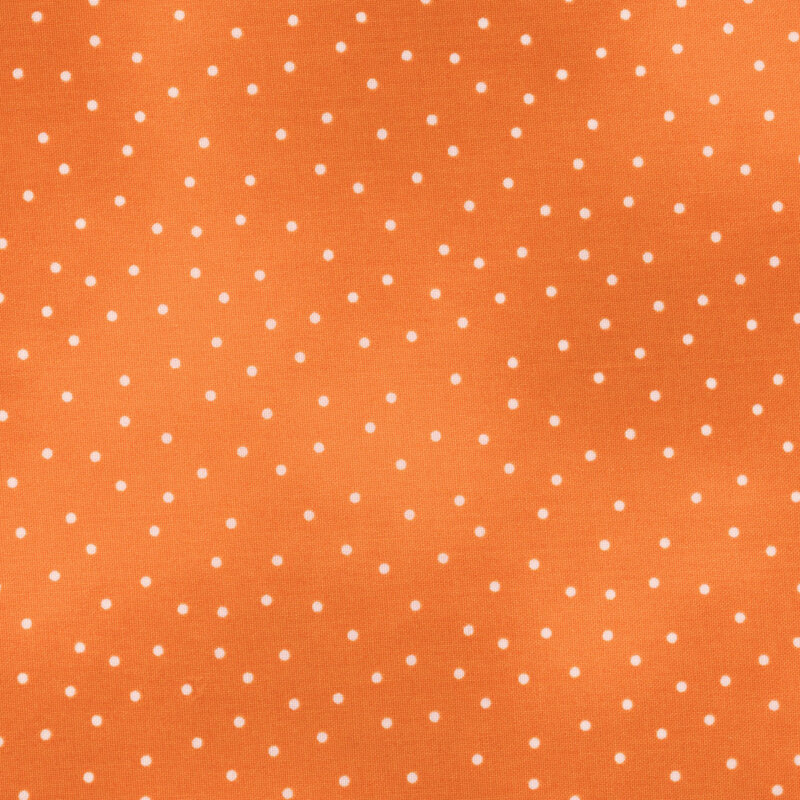 Orange mottled fabric with small white dots throughout