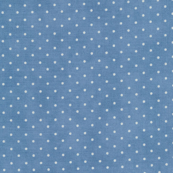 mottled denim blue fabric with tiny cream polka dots