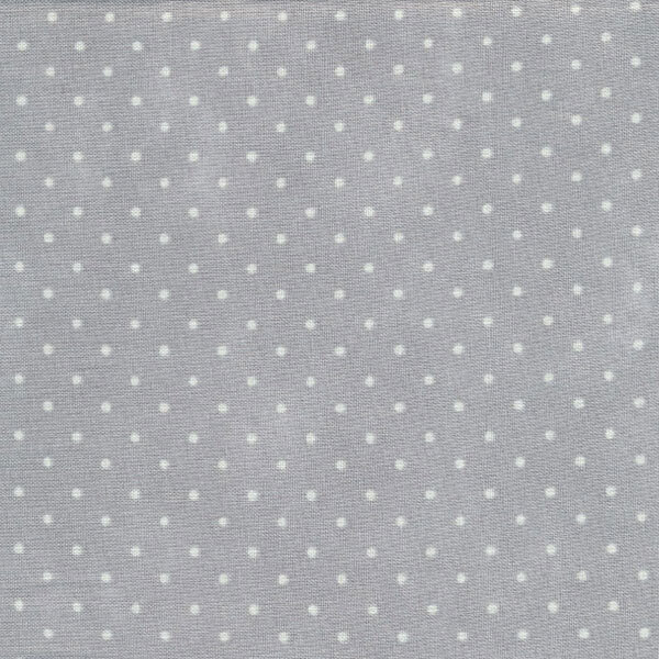 mottled light gray fabric with tiny cream polka dots