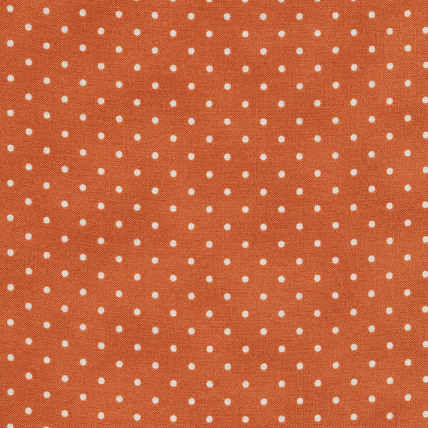 Fabric features tiny cream polka dots on mottled dark orange | Shabby Fabrics