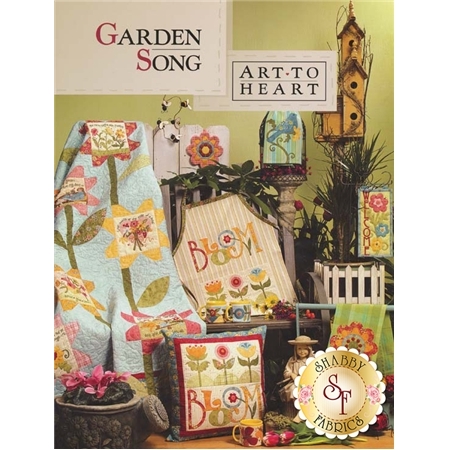 Garden Song Book front cover, featuring a large flower quilt, Bloom apron, Bloom pillow, Flower tea towel, and more spring time projects.