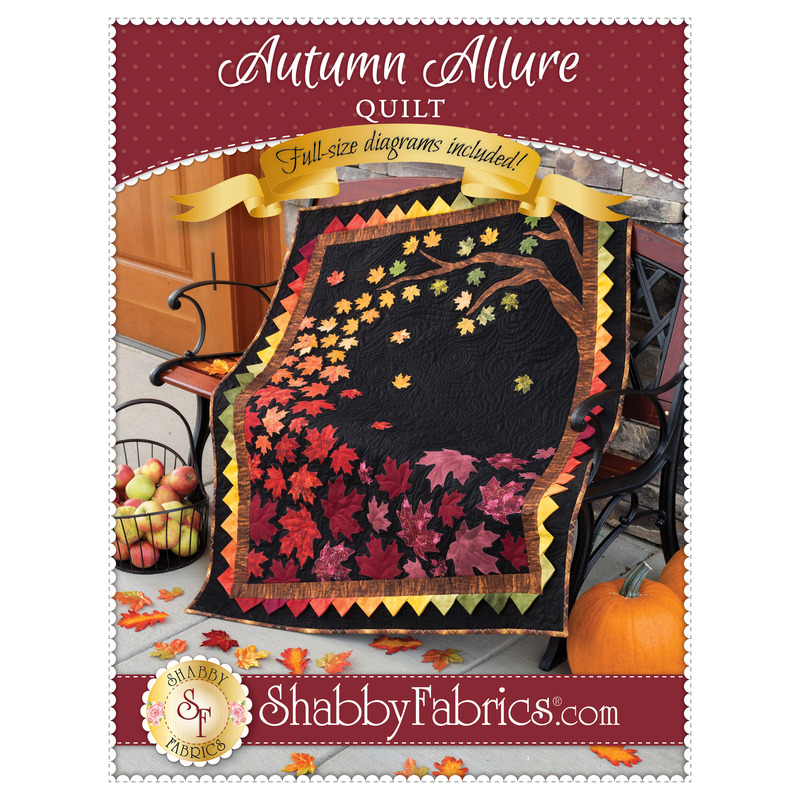 The front of the Autumn Allure Quilt pattern by Shabby Fabrics showing the finished quilt full of falling autumn leaves.