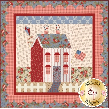 Red and cream cottage house with patriotic flag.