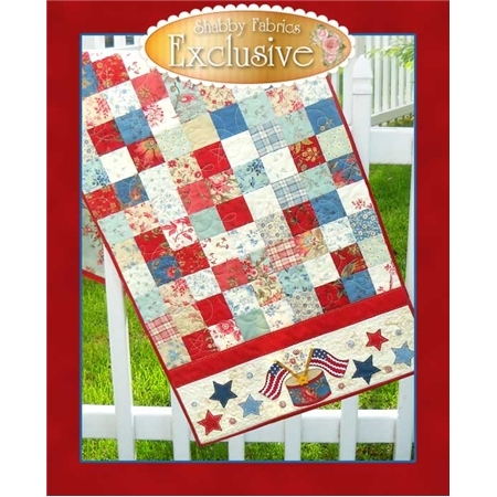 Red, white, and blue table runner made from patchwork squares, with crossed american flag appliques.