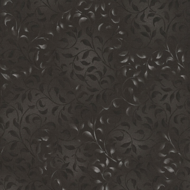black fabric featuring a mottled leafy vine design