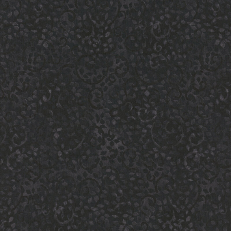 black fabric on a mottled background with sprawling leaves and swirls
