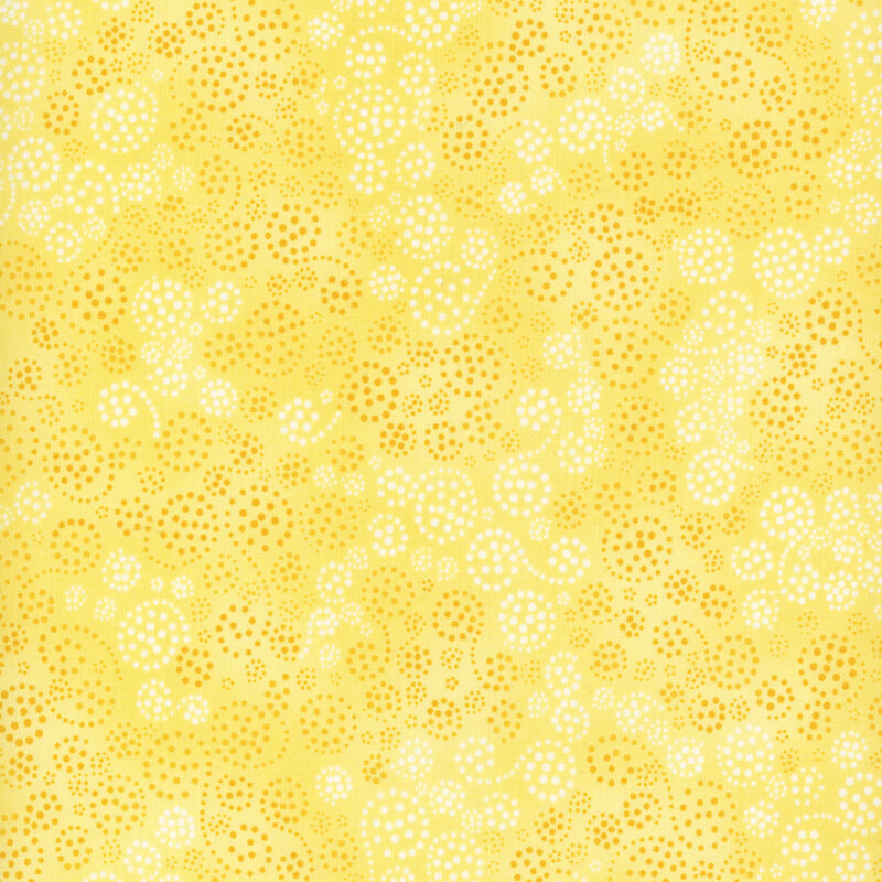 yellow fabric with dark yellow and white dotted swirls