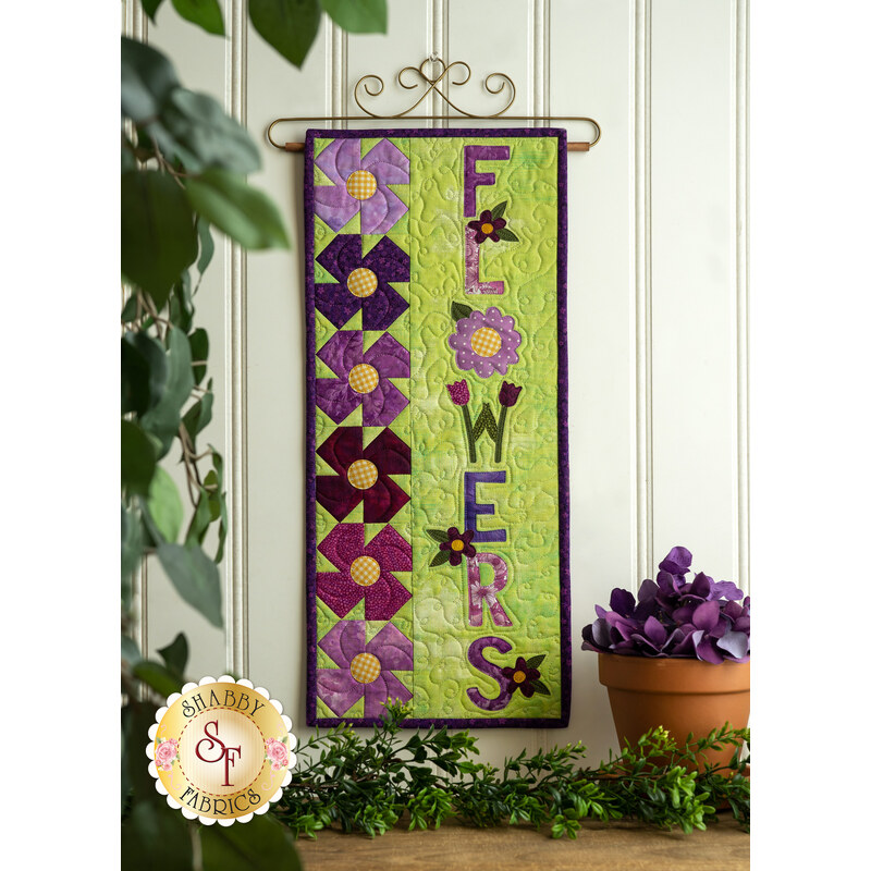 A Year In Words Wall Hanging - May reading Flowers with purple flower pinwheels on green.