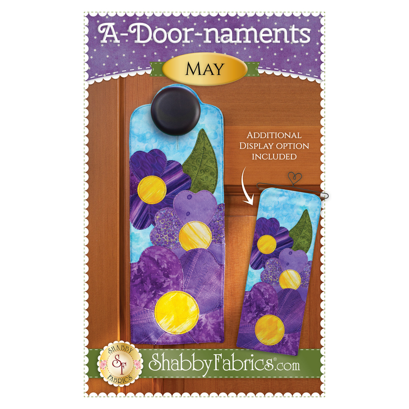 Pattern cover for A-door-naments May with three purple pansies on blue.