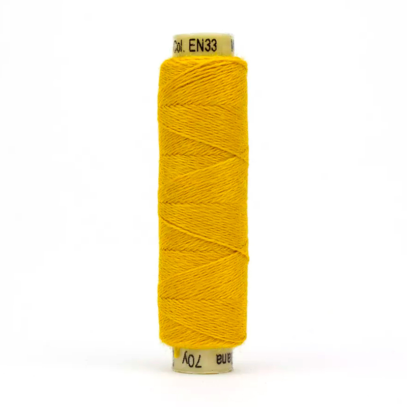 A spool of Ellana EN33 - Goldenrod thread on a white background