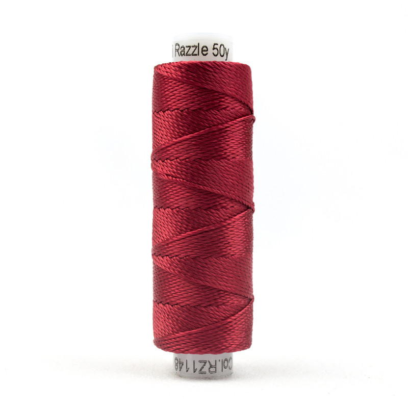 A spool of WonderFil Razzle RZ1148 Tango Red thread on a white background